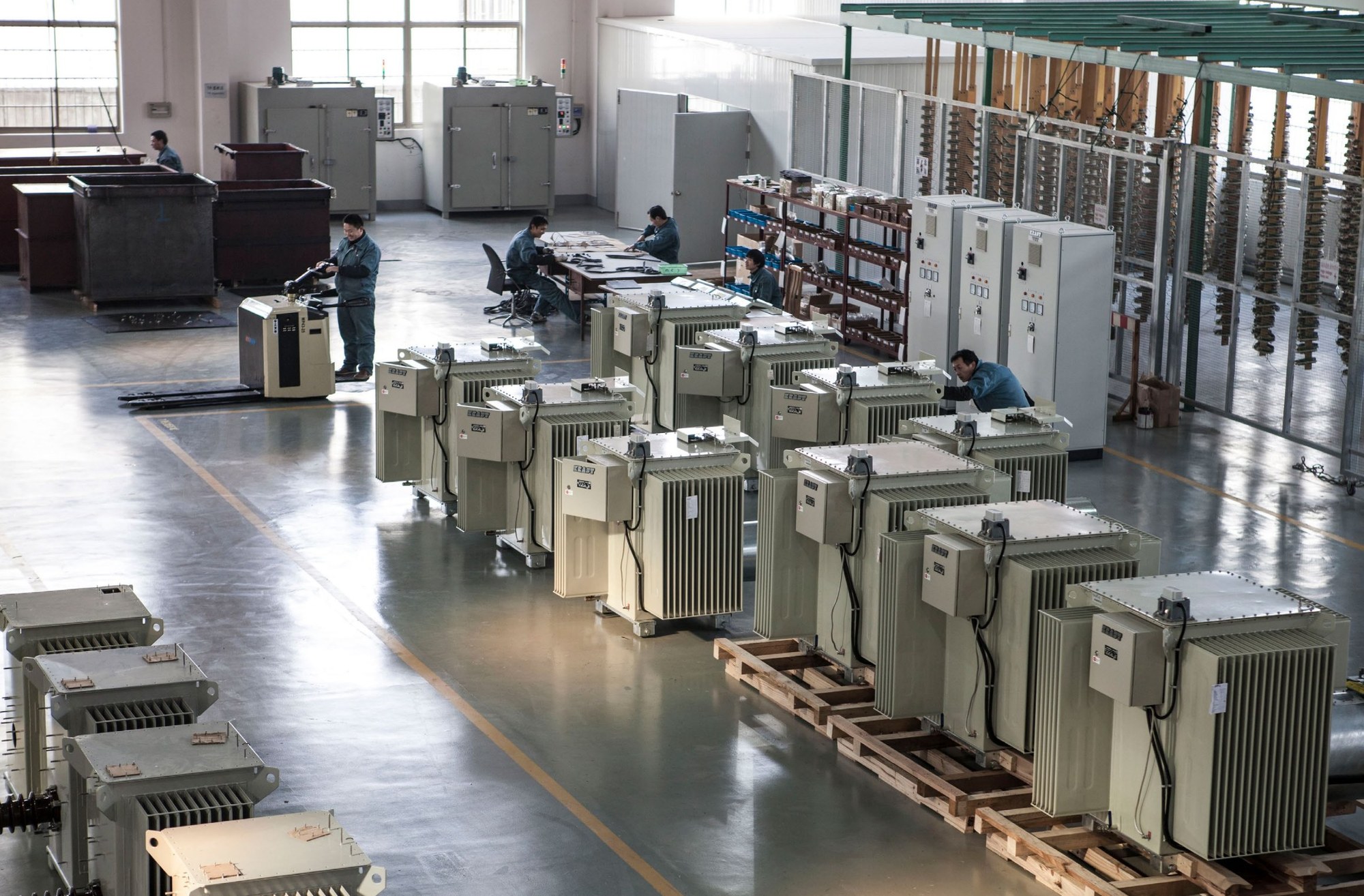 Shanghai warehouse interior with rows of electrical cabinets and workers, 2008