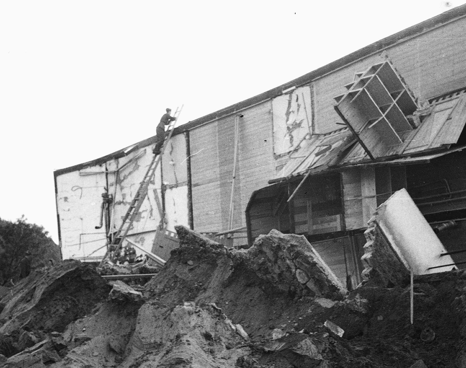 Industrial building partially collapsed into earth and rubble