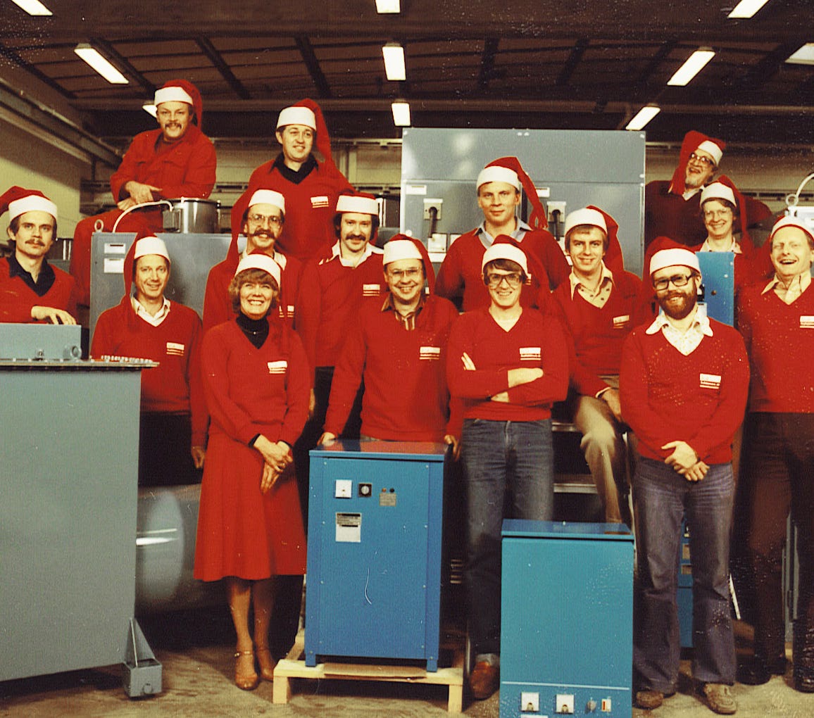 Workers in the production area, Surte, 1980s — red sweaters and Santa hats